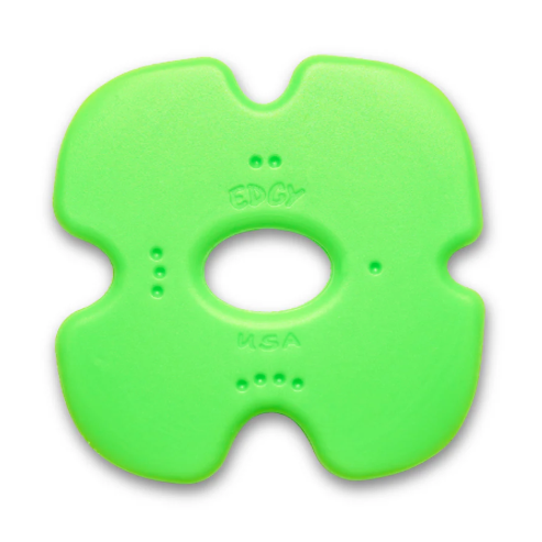 Green plastic tool with a central hole on a white background